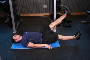 Man with prostatitis performs an exercise in the gym. 